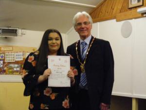 Girl in a black dress receives her award