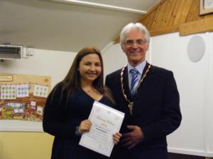 Girl in a black top receives her award