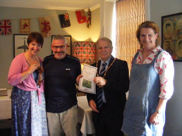 Kevin and Linda being awarded a gold award